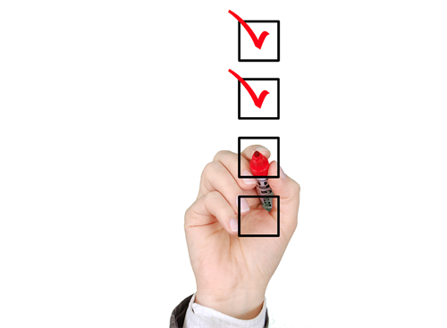 This is an image of a hand filling out a survey.